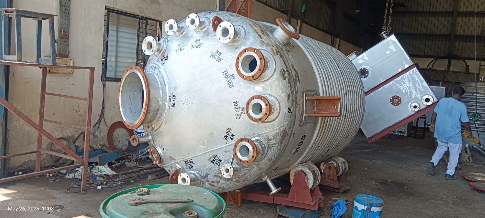 Jacketed process vessel with marked nozzles and manways in a workshop