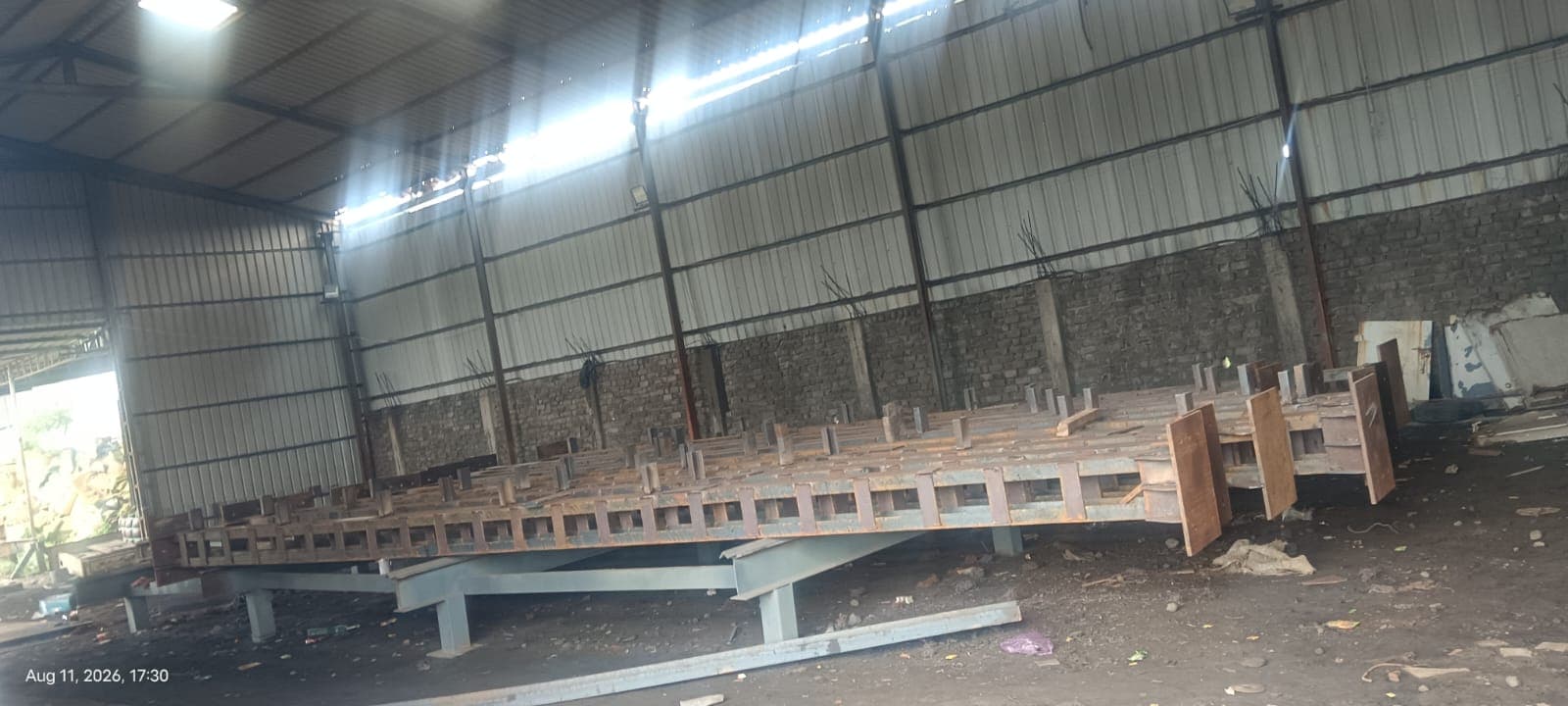 Structural steel platform assembly inside an industrial fabrication shed